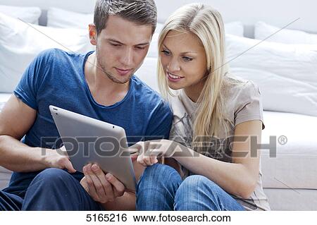 Young couple with ipad View Large Photo Image Stock Photograph - Young couple with ipad . Fotosearch