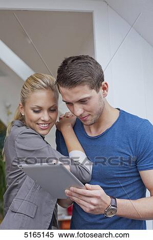 Stock Photography - Young couple with ipad . Fotosearch