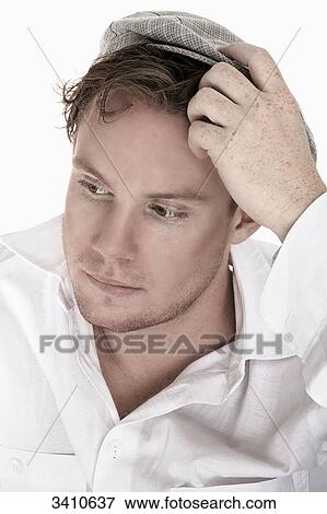 Young man in white shirt with flat cap, portrait View Large Photo Image Stock Photo - Young man in white shirt with flat cap, portrait . Fotosearch