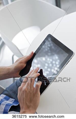 Young man using iPad, close-up View Large Photo Image Stock Photography - Young man using iPad, close-up . Fotosearch
