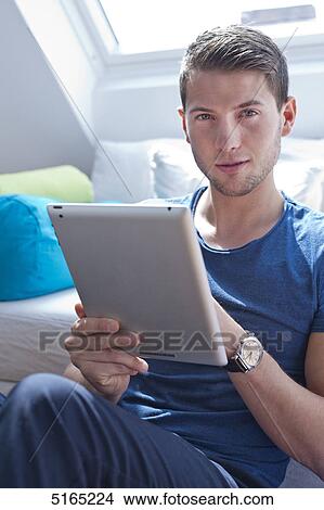 Young man with ipad View Large Photo Image Picture - Young man with ipad . Fotosearch