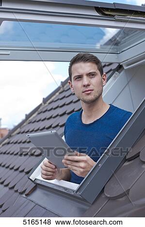 Stock Photo - Young man with ipad . Fotosearch