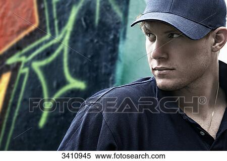 Stock Photography - Young thinking man in front of Graffiti wall . Fotosearch