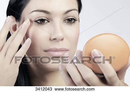Young woman applying eye shadow View Large Photo Image Stock Image - Young woman applying eye shadow . Fotosearch