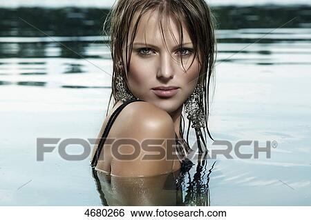 Stock Photograph - Young woman in water . Fotosearch