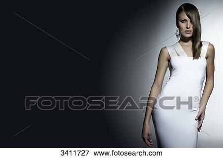 Stock Photo - Young woman in white dress, portrait . Fotosearch