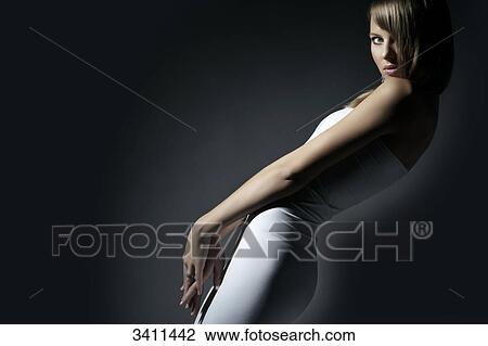 Stock Image - Young woman looking at camera, portrait . Fotosearch