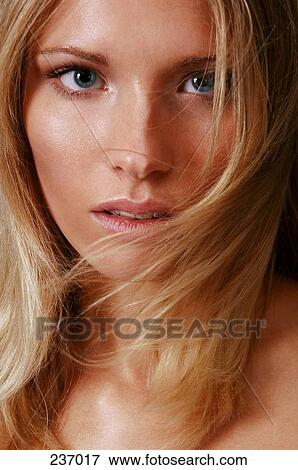 Young woman looking at camera, portrait View Large Photo Image Stock Photo - Young woman looking at camera, portrait . Fotosearch