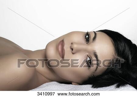 Stock Photo - Young woman looking at camera, portrait . Fotosearch