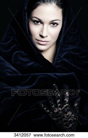 Stock Photo - Young woman shrouded in blue cloth, portrait . Fotosearch