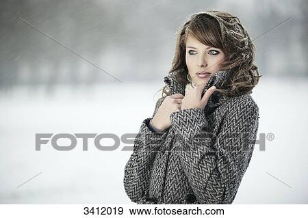 Young woman standing with coat in snow View Large Photo Image Stock Photo - Young woman standing with coat in snow . Fotosearch