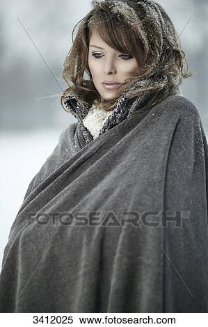 Young woman standing with poncho in snow View Large Photo Image Stock Photography - Young woman standing with poncho in snow . Fotosearch