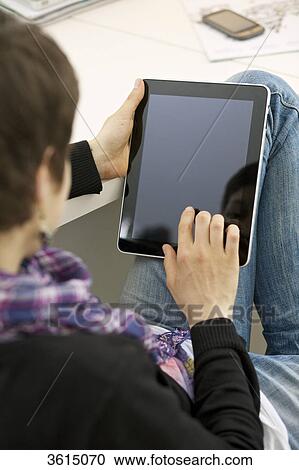 Young woman using iPad View Large Photo Image Stock Image - Young woman using iPad . Fotosearch