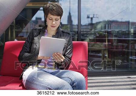 Young woman using iPad View Large Photo Image Stock Image - Young woman using iPad . Fotosearch