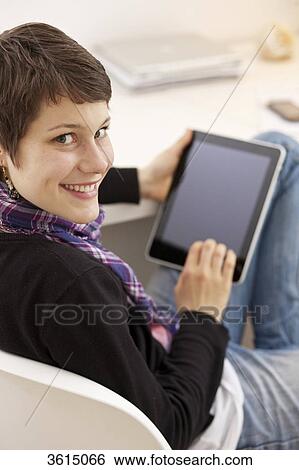 Stock Photograph - Young woman using iPad . Fotosearch
