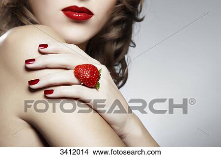 Picture - Young woman with a ring from a strawberry . Fotosearch