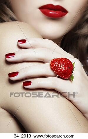Stock Image - Young woman with a ring from a strawberry . Fotosearch