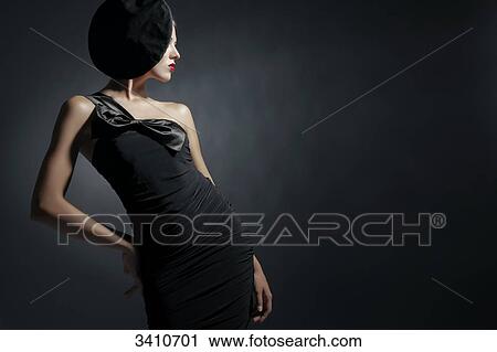 Young woman with black dress and hat View Large Photo Image Stock Image - Young woman with black dress and hat . Fotosearch