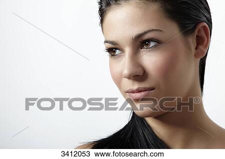 Stock Image - Young woman with black hair, portrait . Fotosearch