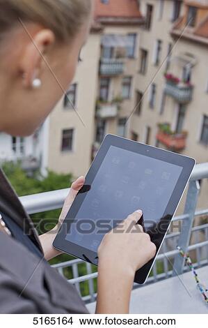 Picture - Young woman with ipad . Fotosearch
