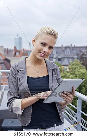 Young woman with ipad View Large Photo Image Stock Image - Young woman with ipad . Fotosearch