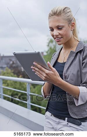 Young woman with ipad View Large Photo Image Stock Image - Young woman with ipad . Fotosearch