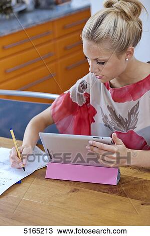 Stock Image - Young woman with ipad . Fotosearch