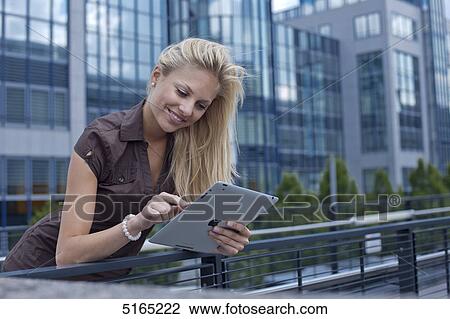 Stock Image - Young woman with ipad . Fotosearch