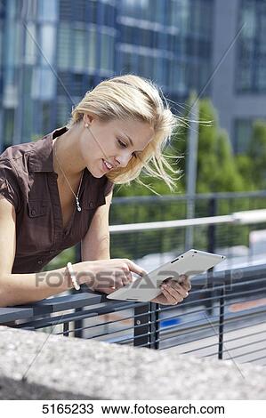 Young woman with ipad View Large Photo Image Stock Image - Young woman with ipad . Fotosearch