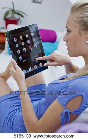 Young woman with ipad View Large Photo Image Stock Photo - Young woman with ipad . Fotosearch