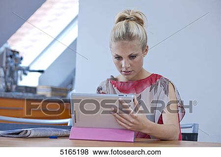 Stock Photo - Young woman with ipad . Fotosearch