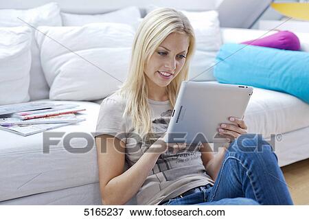 Young woman with ipad View Large Photo Image Stock Photo - Young woman with ipad . Fotosearch
