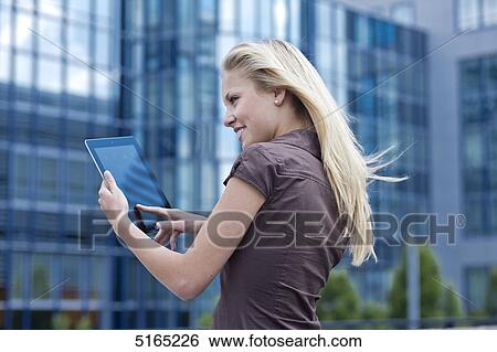 Young woman with ipad View Large Photo Image Stock Photograph - Young woman with ipad . Fotosearch