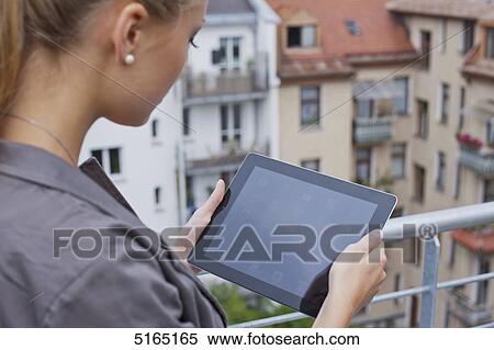 Stock Photography - Young woman with ipad . Fotosearch