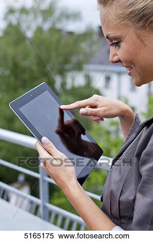 Stock Photography - Young woman with ipad . Fotosearch