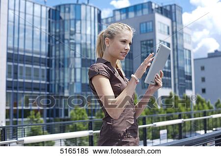 Stock Photography - Young woman with ipad . Fotosearch