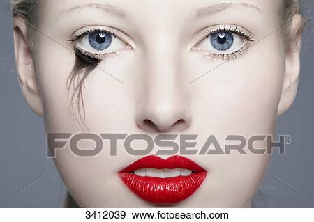 Young woman with red lips and blurred eyeliner, portrait View Large Photo Image Stock Photo - Young woman with red lips and blurred eyeliner, portrait . Fotosearch