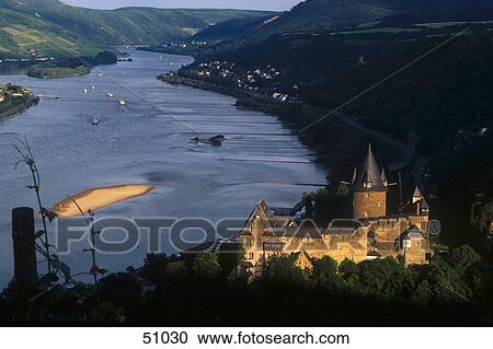 Stock Image - Aerial view of castle at riverside, Stahleck Castle, Bacharach, Rhine River, Rhineland-Palatinate, Germany . Fotosearch