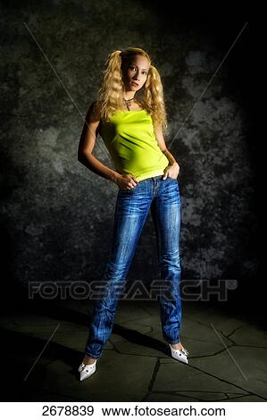 Stock Photo - blonde woman wearing jeans, portrait . Fotosearch