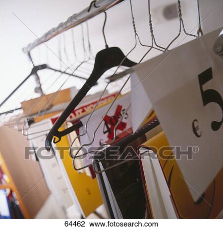Stock Image - Books hanging from hangers for sale . Fotosearch