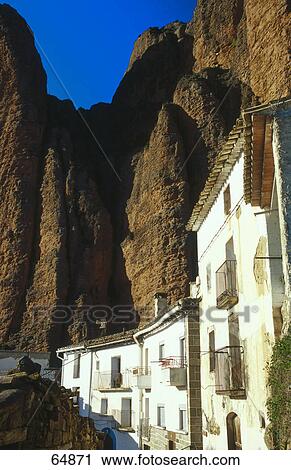 Stock Image - Buildings on foot of mountain, Los Mallos De Riglos, Pyrenees, Huesca, Aragon, France . Fotosearch