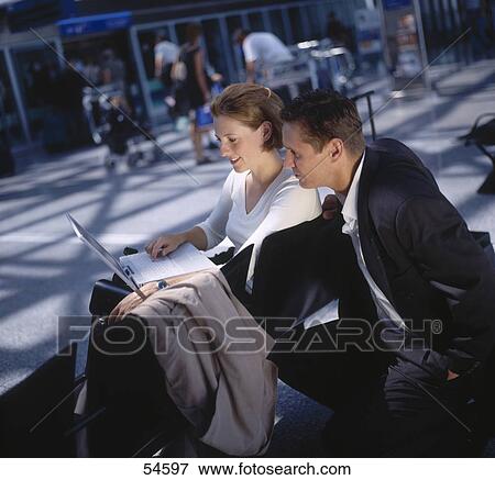 Businessman and businesswoman looking at laptop View Large Photo Image Stock Photo - Businessman and businesswoman looking at laptop . Fotosearch