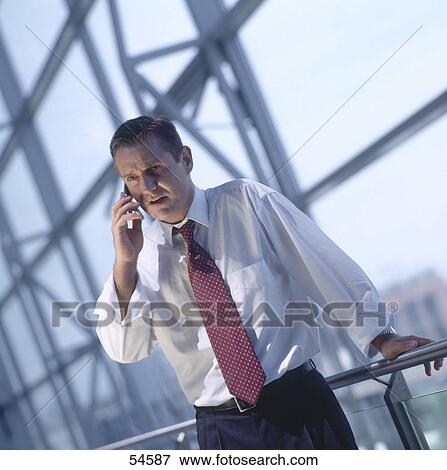 Businessman talking on mobile phone View Large Photo Image Stock Photo - Businessman talking on mobile phone . Fotosearch