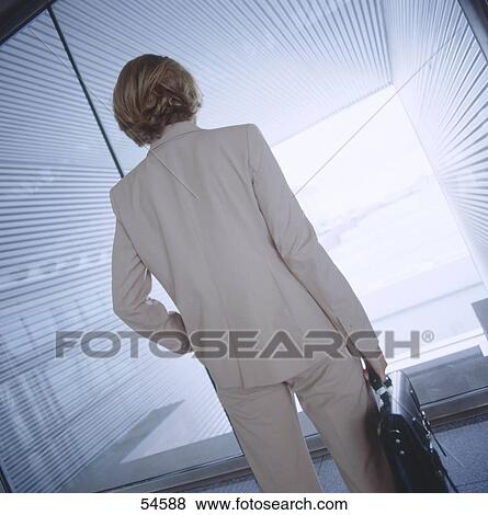 Stock Photo - Businesswoman getting dismissal, rear view . Fotosearch