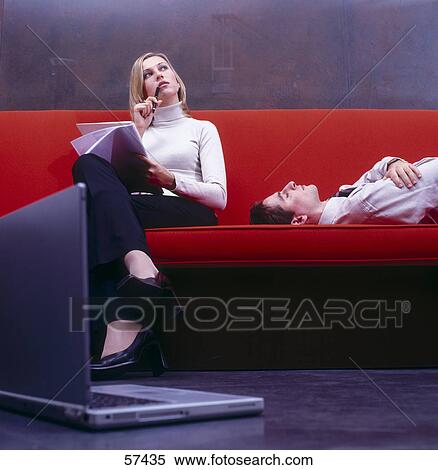 Businesswoman thinking with businessman sleeping on couch View Large Photo Image Stock Photography - Businesswoman thinking with businessman sleeping on couch . Fotosearch