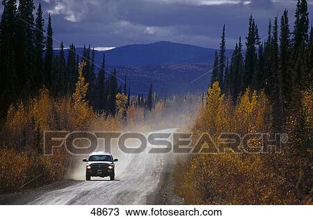 Stock Image - Car on highway, Dempster Highway, Yukon, Canada . Fotosearch