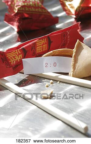 Close-up of 2: 0 fortune sticking out of fortune cookie View Large Photo Image Stock Photo - Close-up of 2: 0 fortune sticking out of fortune cookie . Fotosearch
