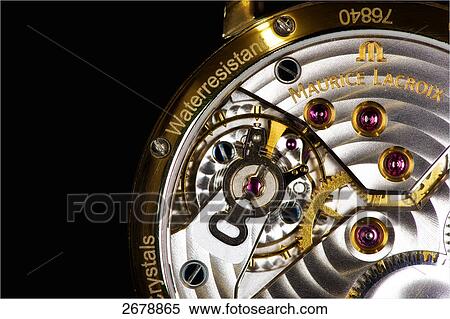 Stock Photography - Close-up of clockwork against black background . Fotosearch