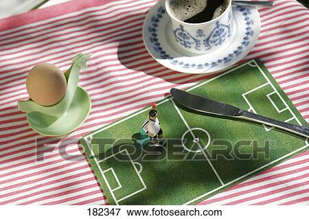 Stock Photo - Close-up of figurine of soccer player and table knife . Fotosearch