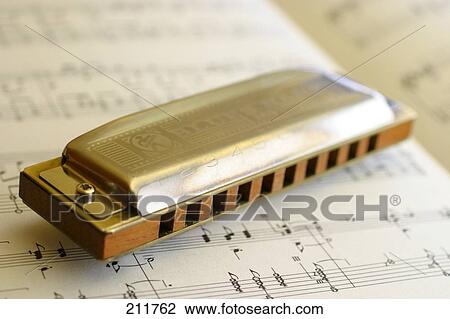 Close-up of harmonica on sheet music View Large Photo Image Stock Image - Close-up of harmonica on sheet music . Fotosearch